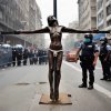 riot squat crucifying protester.jpg