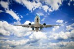 airplane-flying-in-the-blue-sky-with-clouds-istock_27146639_large-2.jpg