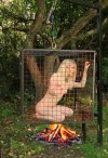 girl in cage hanged over the campfire.jpg
