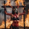 a burning crucified woman covered in blood and wearing a spiked iron mask edit.jpg