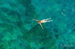 aerial-view-of-a-naked-girl-swimming-in-sea-700-219132269.jpg