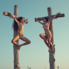 two_crucified_woman_two_separated_crosses_contorted_in_yoga_pose_sky_background_two_rough_wood...png