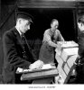 england-1950s-a-uniformed-gwr-railway-guard-from-checking-the-delivery-BJGM8Y.jpg